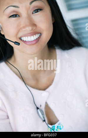 Office Worker Using Telephone Headset Stock Photo