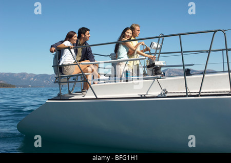 Two young couples sailing on lake Stock Photo