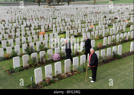 Visitors looking at the Graves of First World War soldiers at Tyne Cot Cemetery Passchendale Ypres Belgium Stock Photo