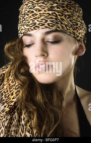 Fashion portrait of a brunette model wearing leopard print. Stock Photo