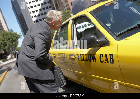Businessman talking to taxi driver Stock Photo