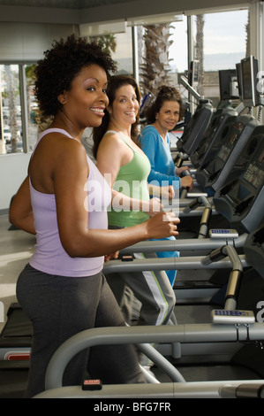 Women Exercising on Treadmills at Health Club Stock Photo