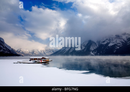 Boathouse in the winter on Lake Minnewanka in Banff National Park in the Canadian Rocky Mountains Stock Photo