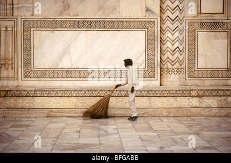 A worker cleaning the marble floor before sunrise outside the Taj Mahal, Agra IN Stock Photo