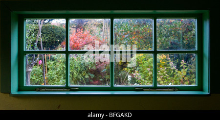 White window of The Boathouse Tearoom seen from the inside at the Priest's House Museum gardens in Wimborne, Dorset Stock Photo