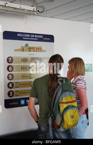 couple reading sign on Cross Channel Ferry Stock Photo