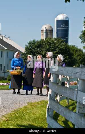 Young amish women friends walking down country lane road in Lancaster PA.   housewives Stock Photo