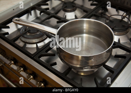 Pan of water boiling on a gas stove. Stock Photo