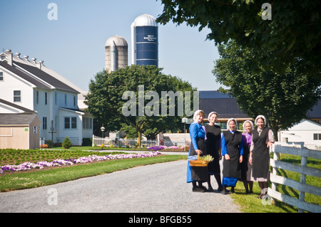 Young amish women friends walking down country lane road in Lancaster PA.   housewives Stock Photo