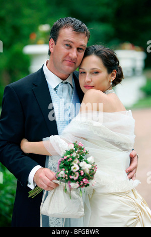 Three quarter body portrait of happy newlywed middle aged couple on wedding day. Stock Photo