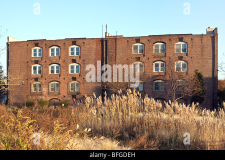 gentrified old brick warehouse with arched openings converted to condominiums on the historic Red Hook waterfront Brooklyn NY Stock Photo