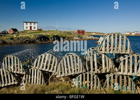 lobster traps and traditional saltbox house in the village of Tilting, Fogo Island, Newfoundland & Labrador, Canada Stock Photo