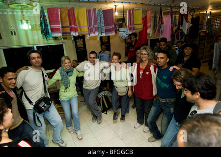 A spontaneous party involving locals and tourists in a roadside café Stock Photo