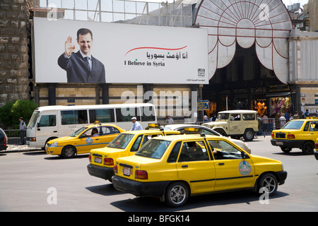 Poster with Bashar al-Assad smiling and saluting at the entrance of the bazaar, Damascus, Syria, Middle East Stock Photo