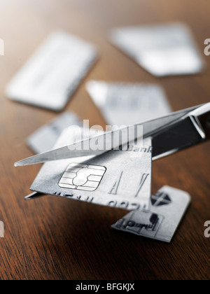 Credit card being cut up with scissors Stock Photo