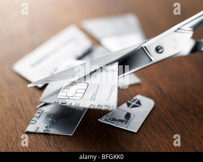 Credit card being cut up with a scissors Stock Photo