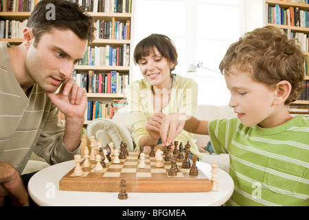father and son playing chess Stock Photo