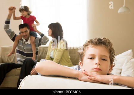 boy thinking in front of family Stock Photo