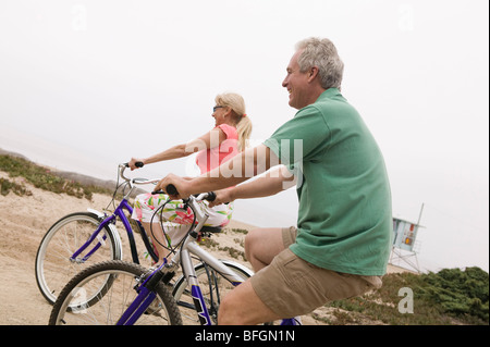 Middle-aged couple riding bicycles Stock Photo