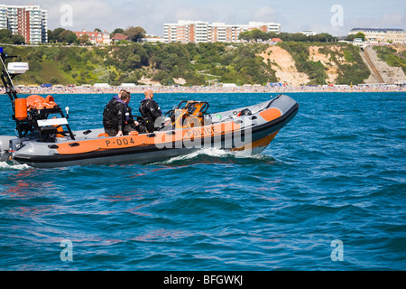 Officers from the Dorset Police Marine Section, patrol off shore along Bournemouth beach and seafront, Dorset. UK. Summer. Stock Photo