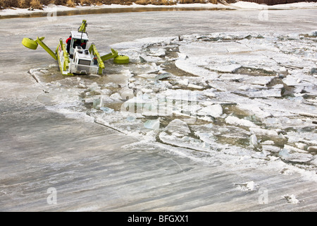 Amphibex machine breaking up ice on the Red River, during 2009 flood, near Selkirk, Manitoba, Canada.  Just north of Winnipeg. Stock Photo