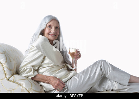 Senior Woman Having Glass of Champagne Stock Photo