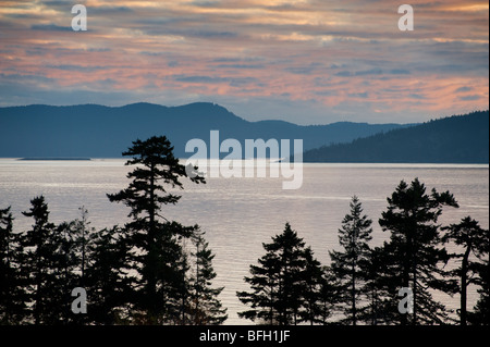 Sunset descends on Puget Sound and the San Juan Islands with a view looking west across Rosario Strait toward Orcas Island. Stock Photo