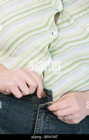 Overweight woman, mid-section Stock Photo