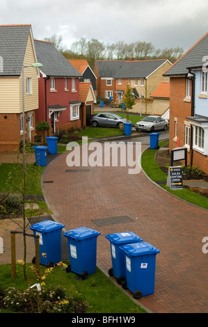Multiple blue recycling bins placed along a street awaiting collection in Sudbury, Suffolk, England. Stock Photo