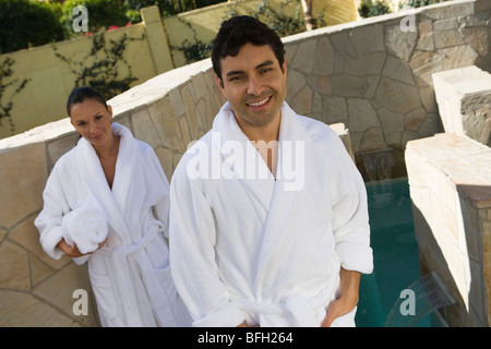 Portrait of couple in bathrobes, outdoors Stock Photo