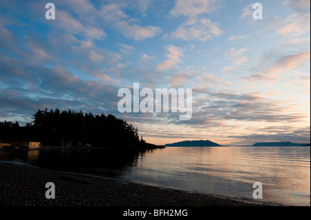 Sunset descends on Puget Sound and the San Juan Islands with a view looking west across Rosario Strait toward Orcas Island. Stock Photo