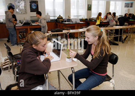 High school students collecting data on a plant experiment, learning science in classroom Stock Photo