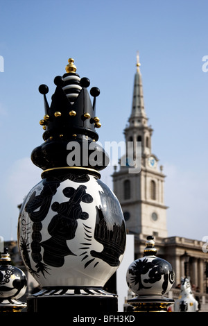 Giant ceramic chess set in Trafalgar Square with black Queen in the foreground and St Martin in the Field church in the distance Stock Photo