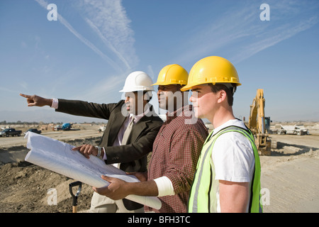 Surveyor and construction workers on site Stock Photo
