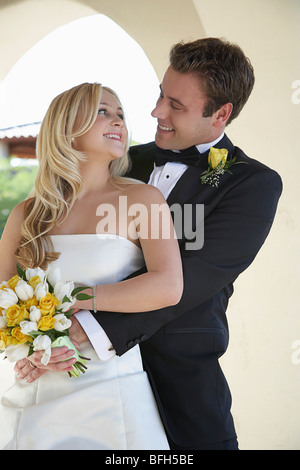Groom embracing bride, portrait Stock Photo