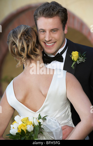 Groom (facing camera) and bride dancing Stock Photo
