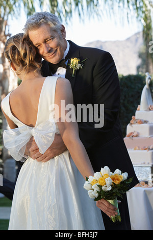 Father (facing camera) and bride dancing Stock Photo