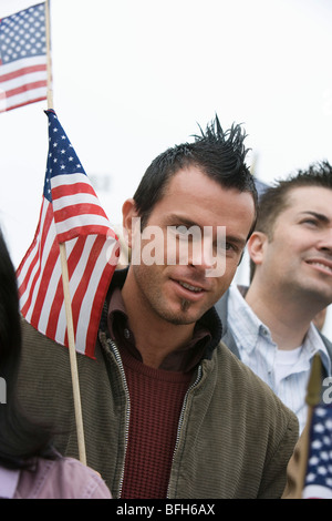 Young man holding American flag isolated on white background Stock ...