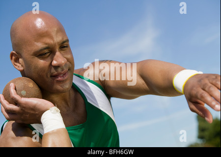 Male shot putter holding shot Stock Photo