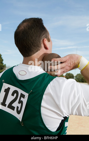 Male shot putter holding shot Stock Photo