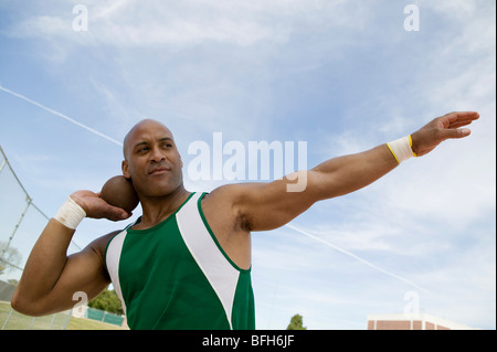 Male shot putter holding shot Stock Photo