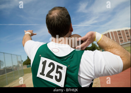 Male shot putter holding shot Stock Photo