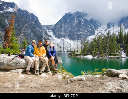 Two adult couples posing for a group portrait at Colchuck Lake in the Cascades of Washington, USA. Stock Photo