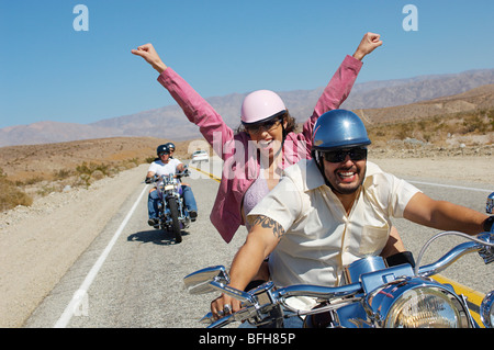 Bikers riding on desert road Stock Photo
