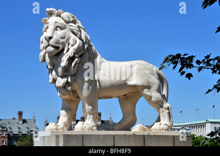 Historical statue of the South Bank Coade stone sculpture of male Lion on a blue sky day at the Lambeth end of  Westminster Bridge London England UK Stock Photo