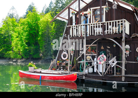 Float home and canoe at marina in Genoa Bay, near Duncan, BC. Stock Photo