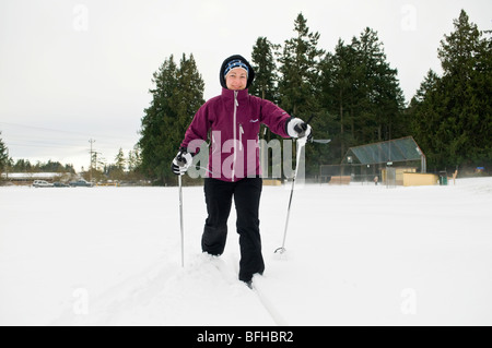 A woman cross country skiing in a park in Central Saanich near Victoria BC. Stock Photo