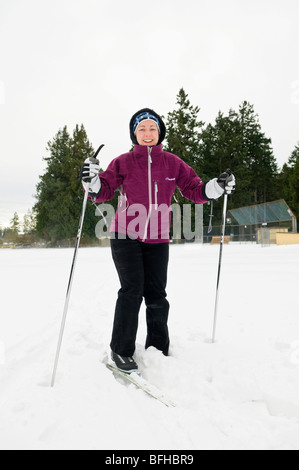 A woman cross country skiing in a park in Central Saanich near Victoria BC. Stock Photo