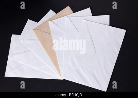 closed envelopes with white spot light on black background Stock Photo