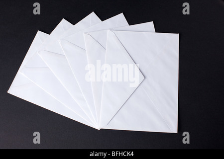closed envelopes with white spot light on black background Stock Photo